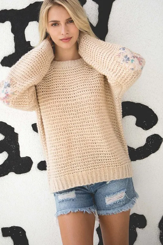 Basic ribbed pullover sweater with multi-colored floral elbow patch