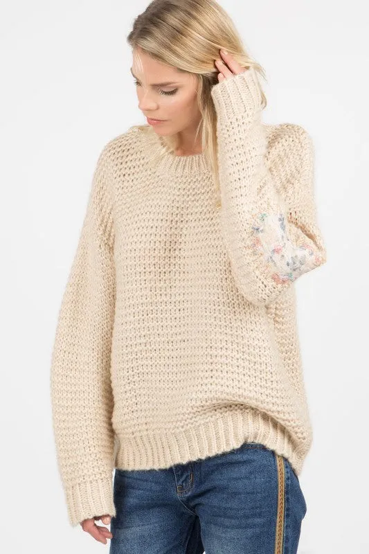 Basic ribbed pullover sweater with multi-colored floral elbow patch